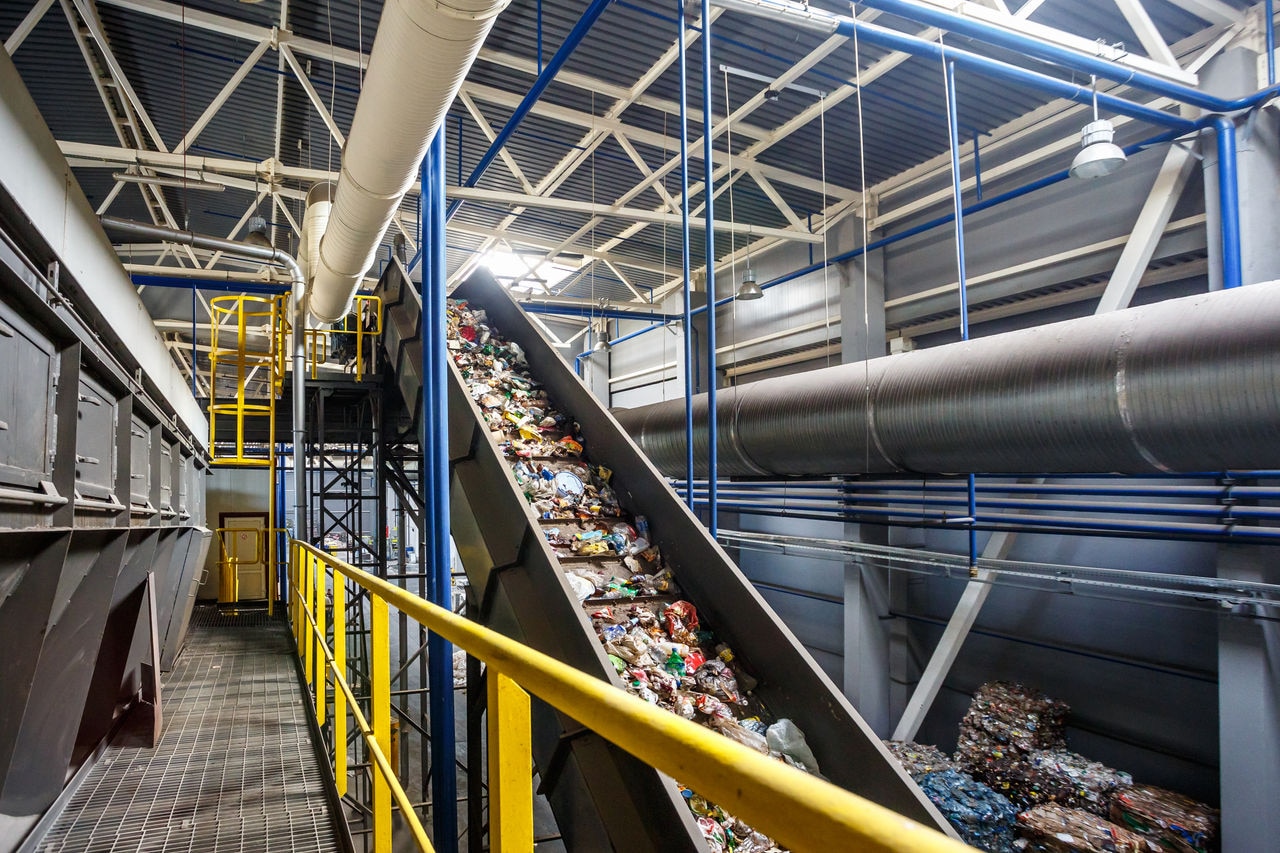 Moving conveyor transporter on Modern waste recycling processing plant. Separate and sorting garbage collection. Recycling and storage of waste for further disposal.